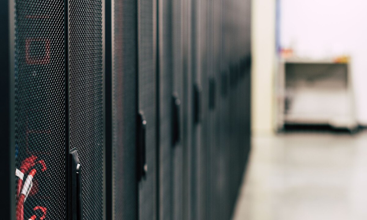 A row of secure server cabinets in a data-centre aisle